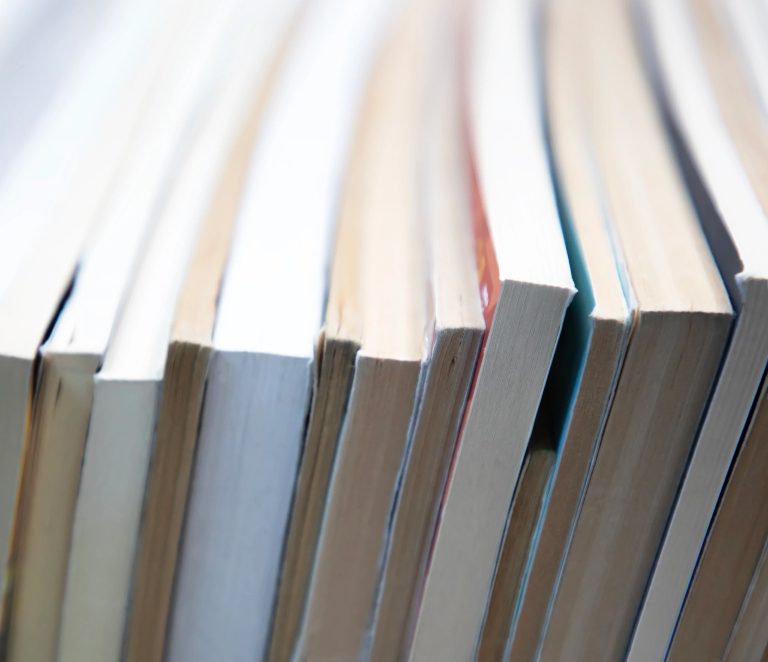 Stack of books with warm tones and copy space