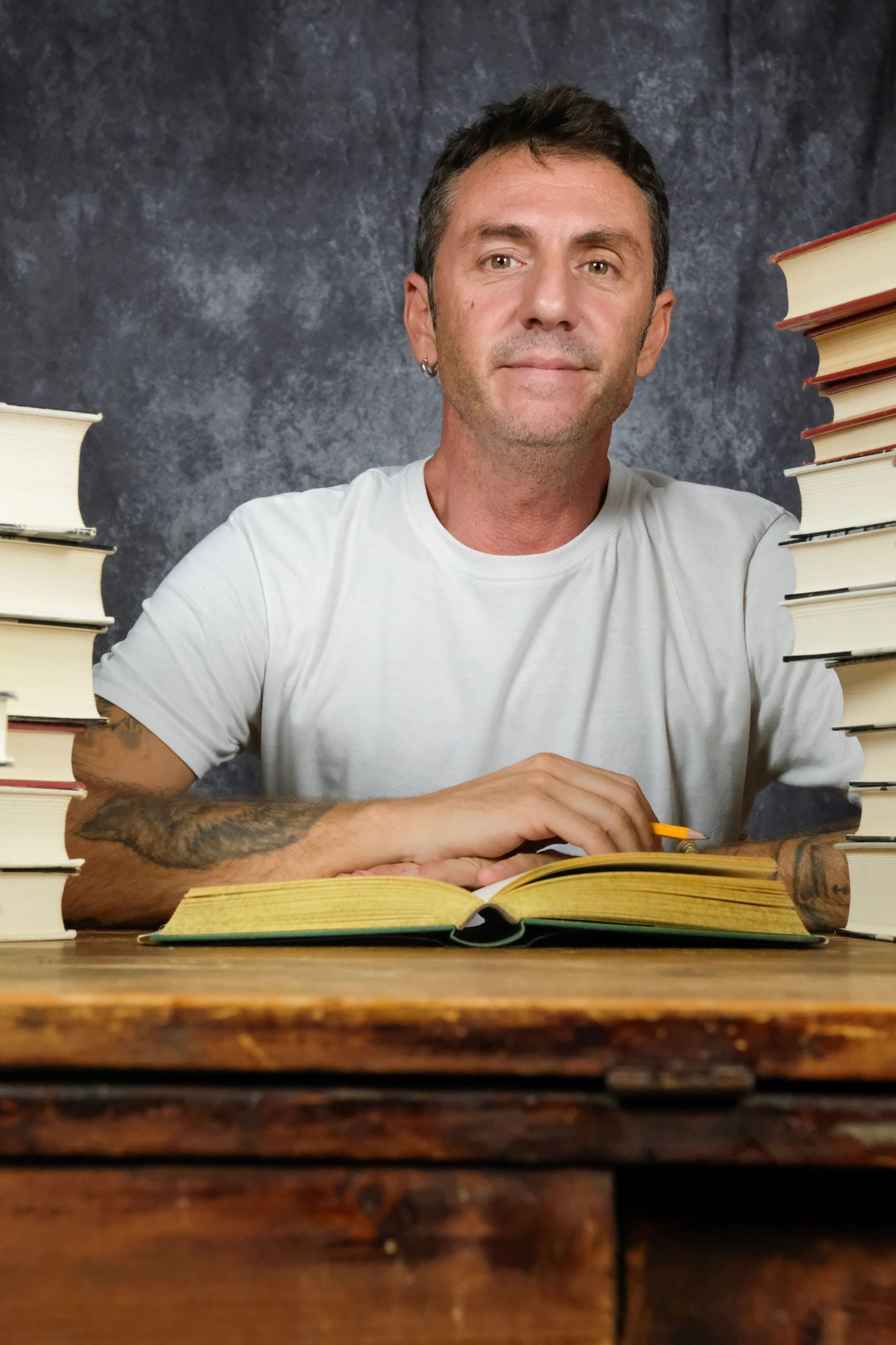 Portrait of an author against a dark studio background