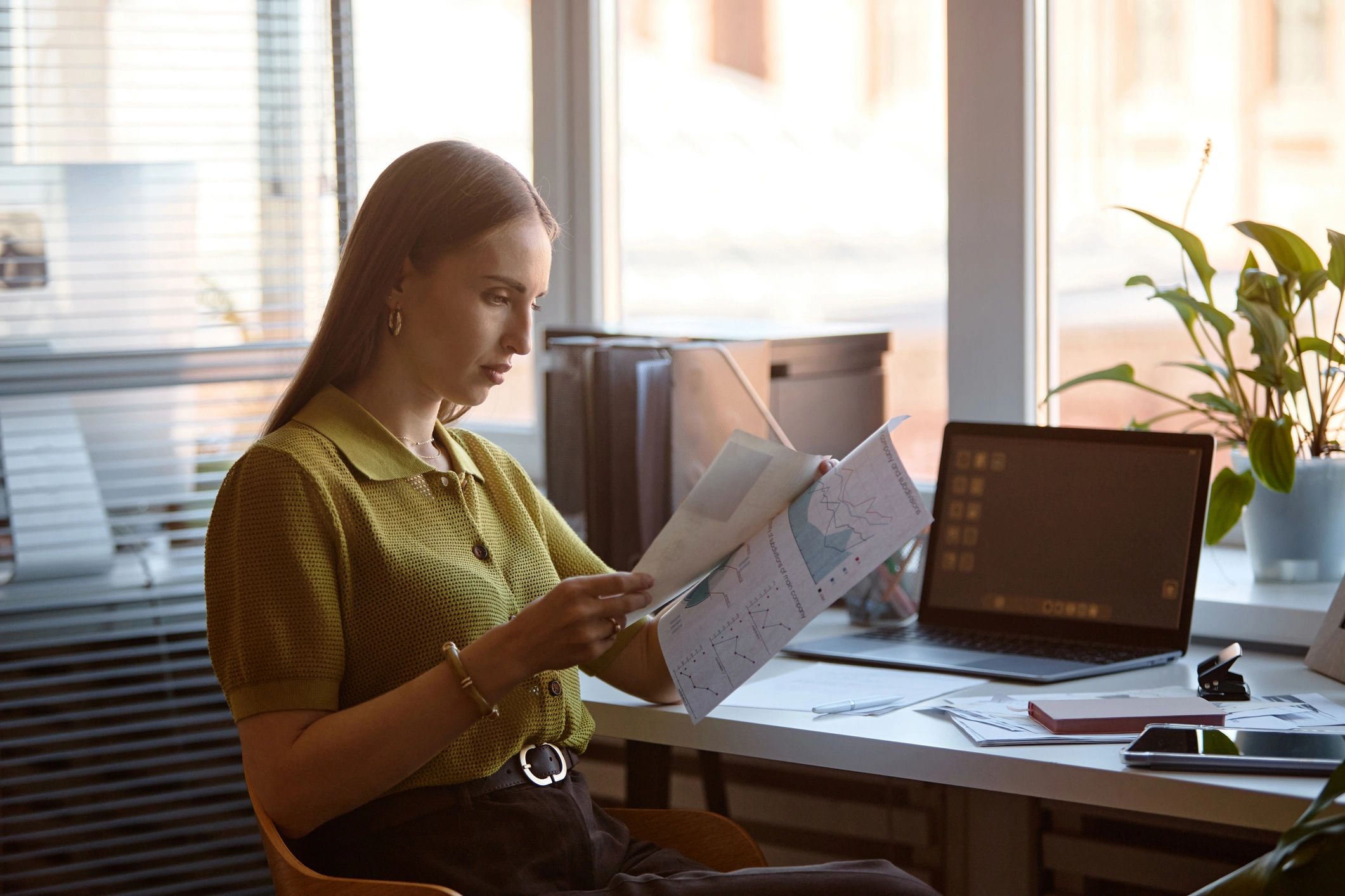 Editor reviewing printed pages at a desk